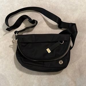 Lululemon crossbody purse in black with gold detailing.